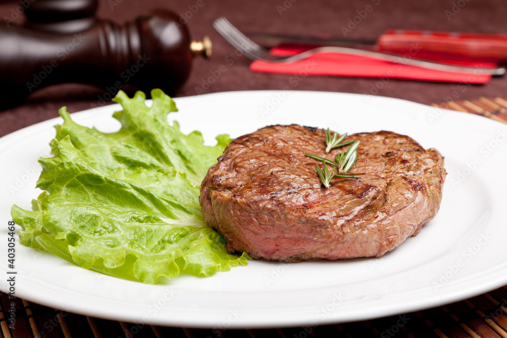 Grilled steak on a white plate