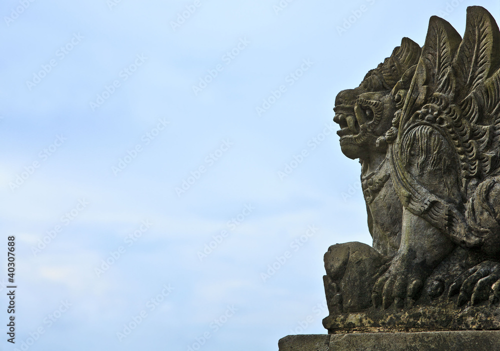 Traditional Balinese God statue, at Ocean, Bali, Indonesia.