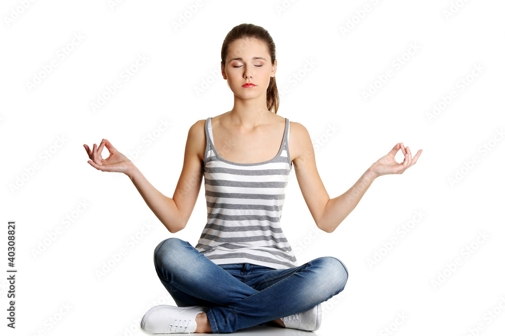 Student girl over white background meditating in lotus pose Student girl over white background meditating in lotus pose