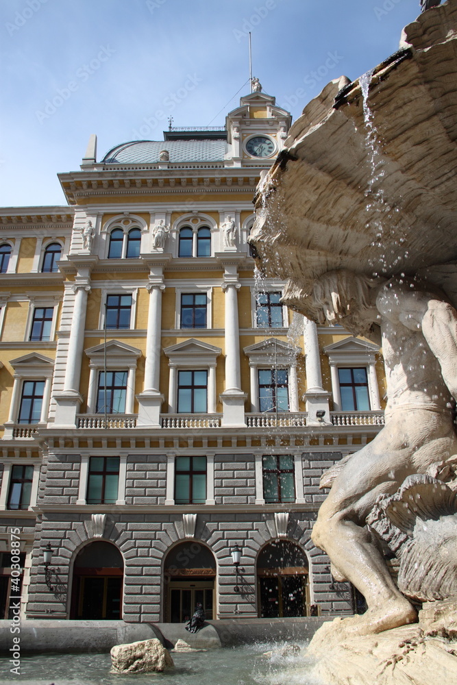 Fountain and a historic building in Trieste, Italy