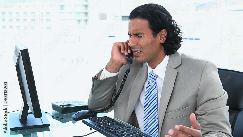 Businessman having trouble while phoning