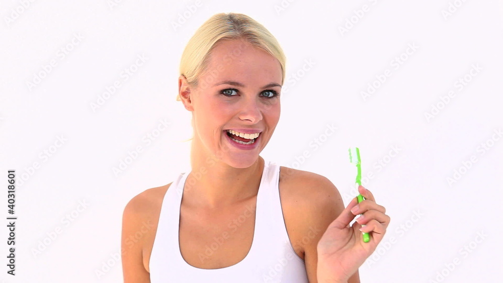 Blonde using a toothbrush Blonde using a toothbrush