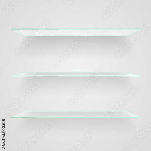 Glass shelves on light grey background