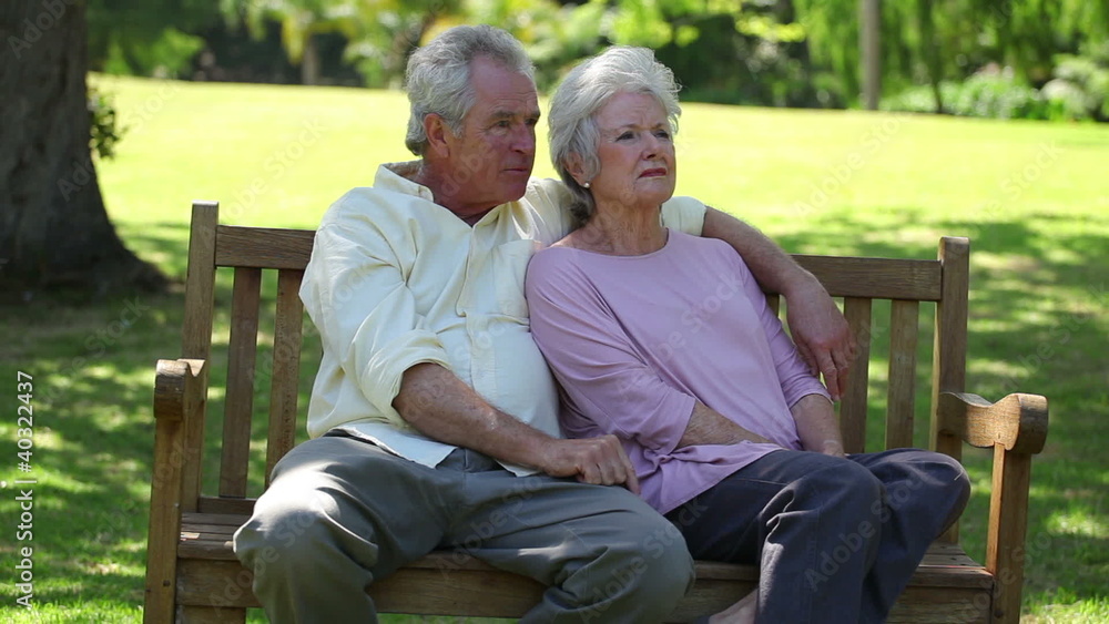 Retired couple sitting on a bench Retired couple sitting on a bench