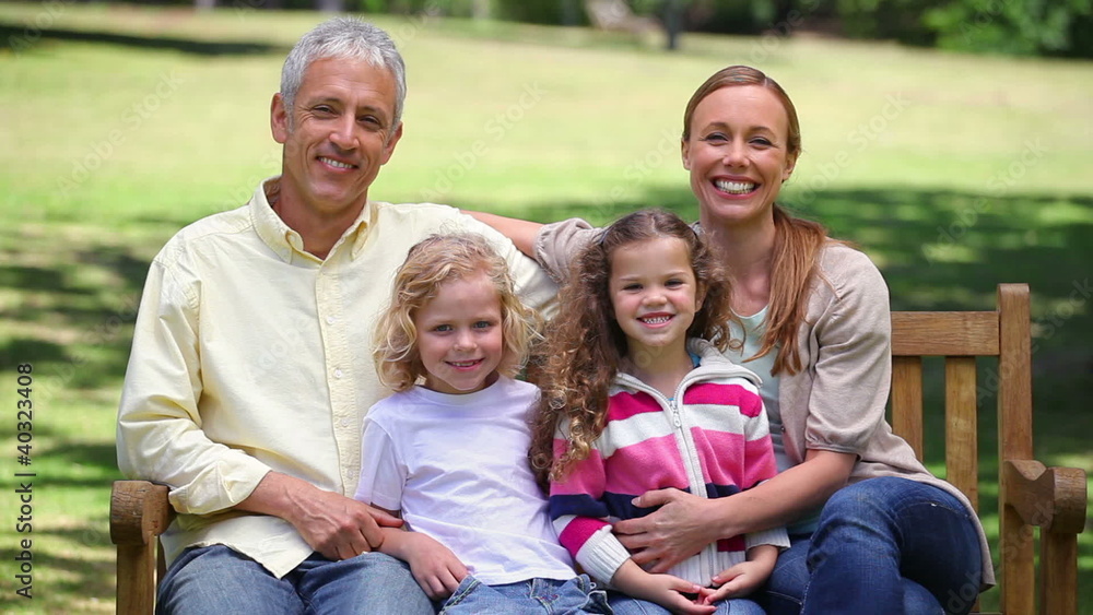 Family posing together on a bench Family posing together on a bench