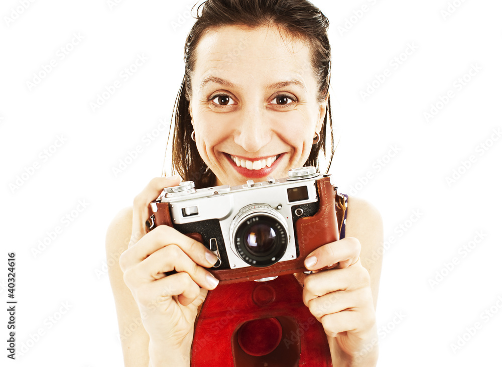 An excited young woman holding a camera in hand An excited young woman holding a camera in hand