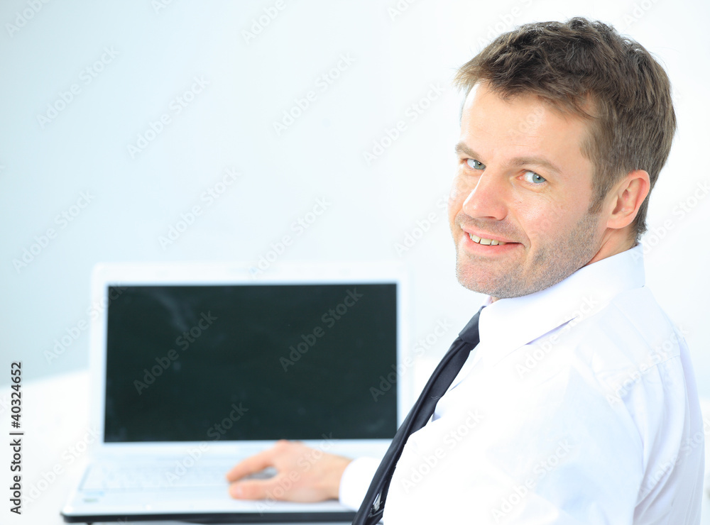 Portrait of handsome young business man and laptop Portrait of handsome young business man and laptop