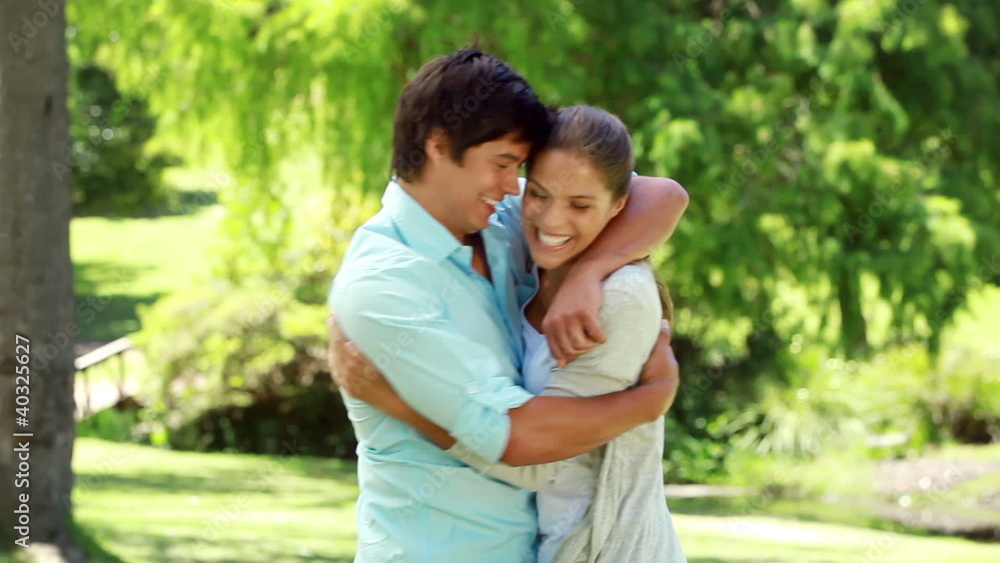 Smiling woman running and then embracing her boyfriend Smiling woman running and then embracing her boyfriend