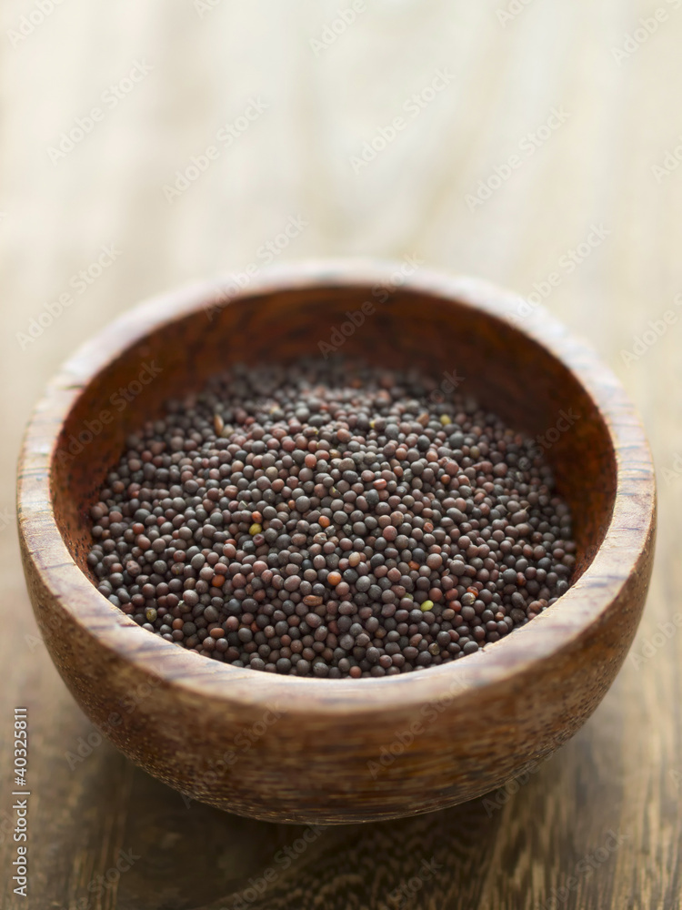 close up of a bowl of black mustard seeds close up of a bowl of black mustard seeds