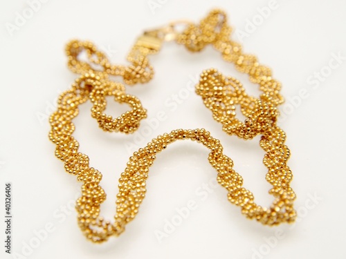 Yellow gold jewellry, isolated towards white background