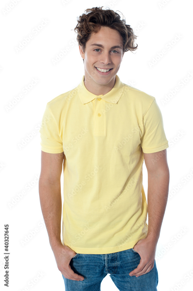 Portrait of a stylish guy standing with hands in pockets Portrait of a stylish guy standing with hands in pockets