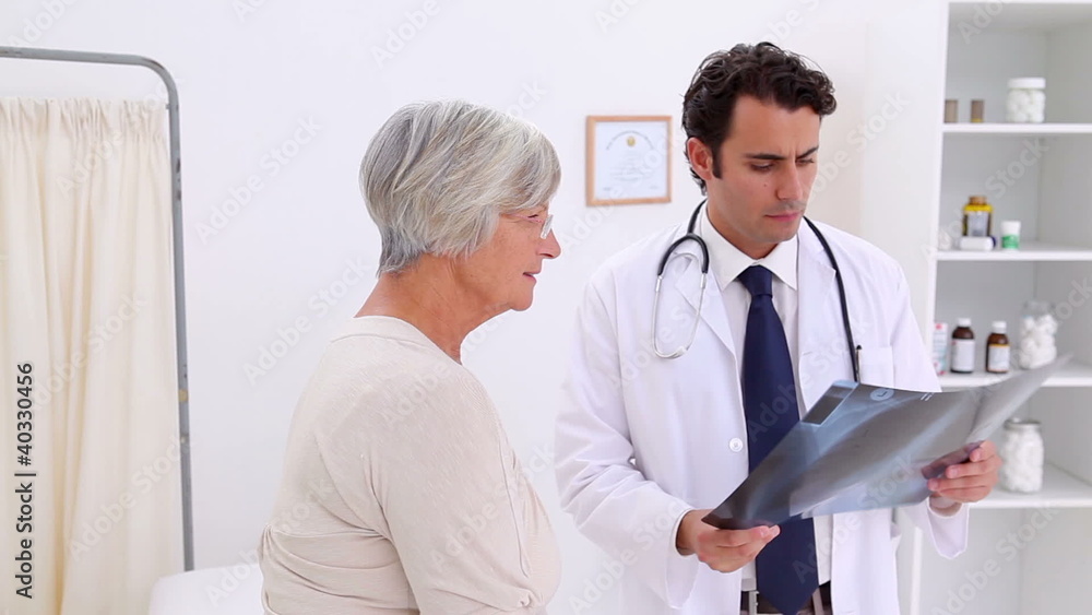 Doctor showing an x-ray to her patient Doctor showing an x-ray to her patient