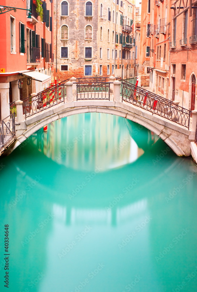 Naklejka premium Venice, Bridge on water canall. Long exposure photography.