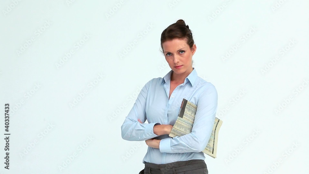 Businesswoman with a newspaper crossing her arms Businesswoman with a newspaper crossing her arms