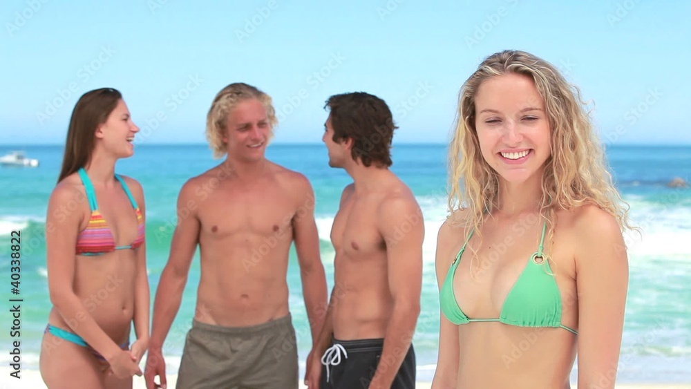 Blonde women standing in front of her friends Blonde women standing in front of her friends