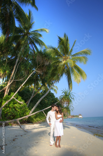 Sensual happy lovers in white clothes on the beach (Maldives)