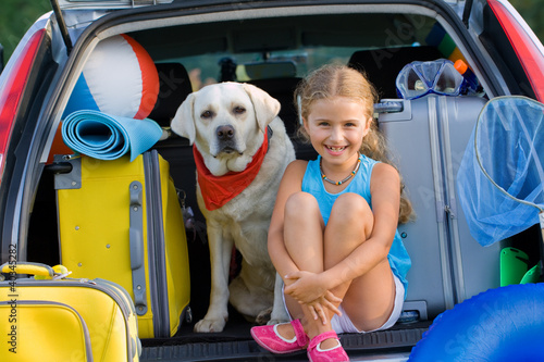 Travel, lovely girl with dog ready for family travel