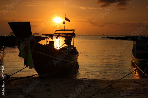 boat on the beach at sunset time