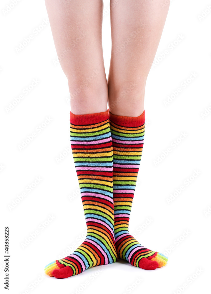 female legs in colorful striped socks isolated on white female legs in colorful striped socks isolated on white