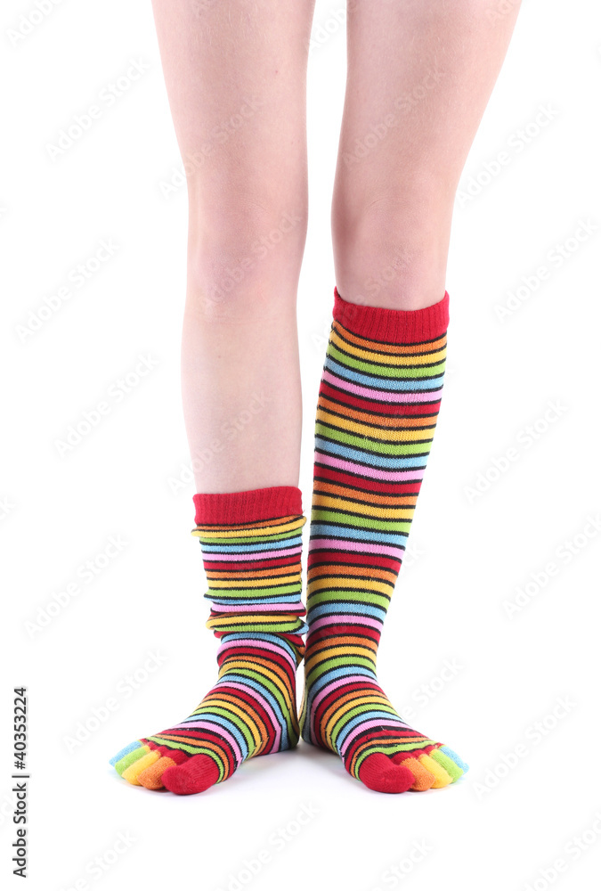 female legs in colorful striped socks isolated on white female legs in colorful striped socks isolated on white