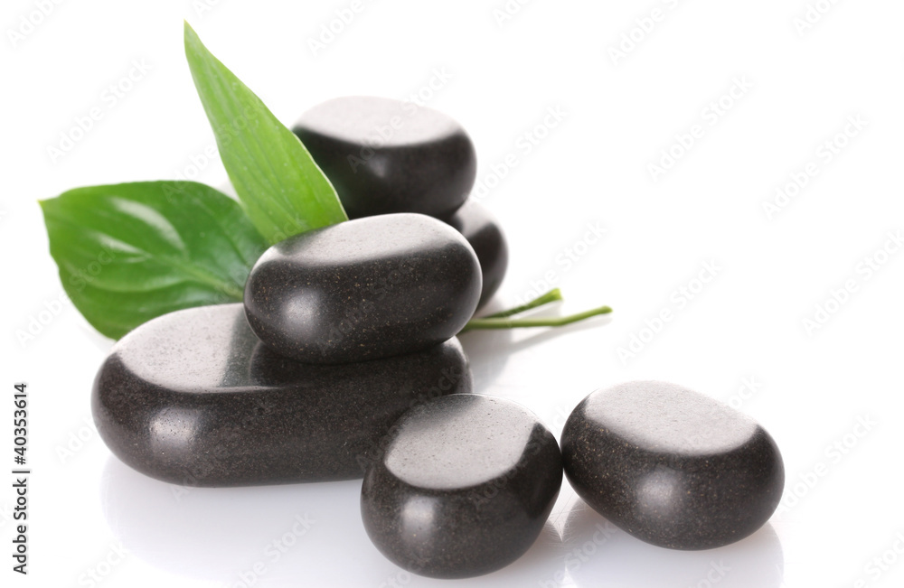 Spa stones and green leaves isolated on white Spa stones and green leaves isolated on white
