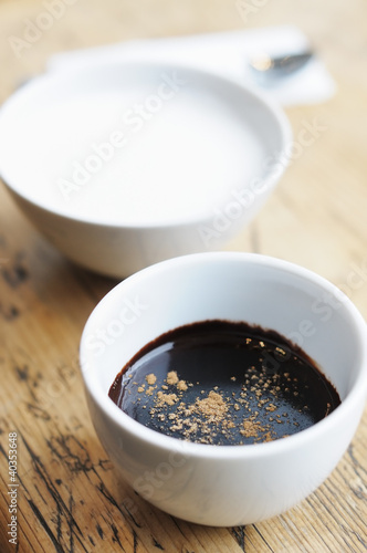 Hot chocolate with spice and milk in white cups
