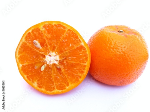 half sliced and one whole orange