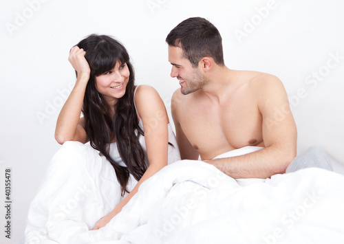 Couple waking up in bed