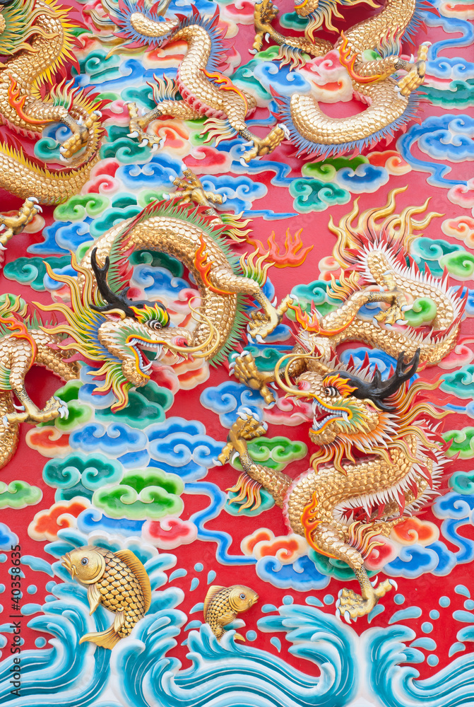 chinese dragon statue  on temple wall in Thailand