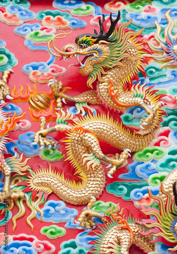 chinese dragon statue on temple wall in Thailand