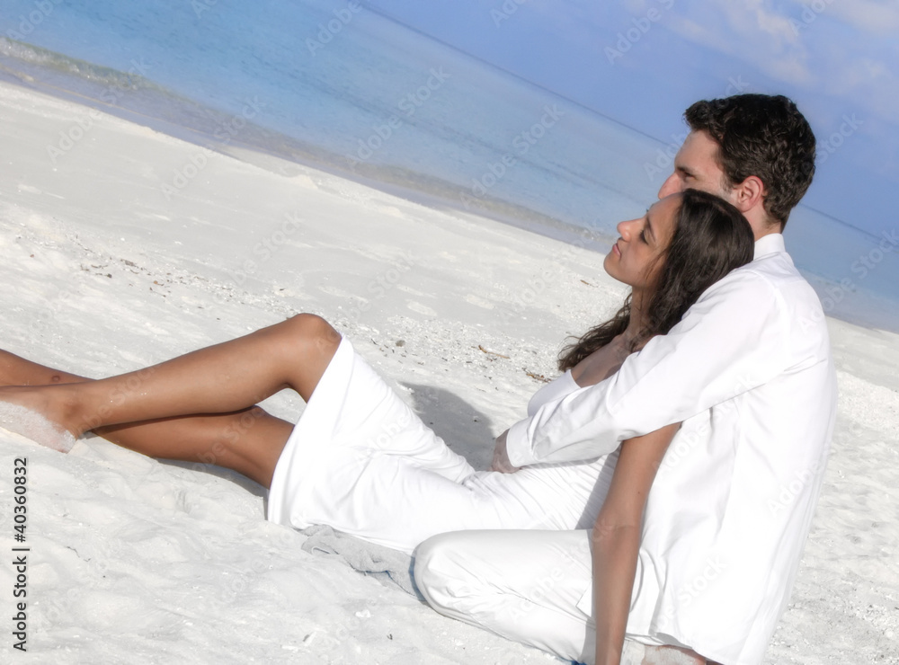 Sensual happy lovers in white clothes on the beach (Maldives)