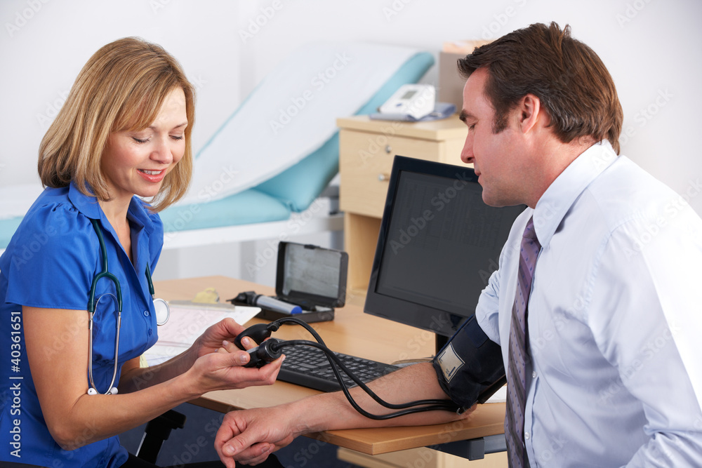 UK doctor taking patient's blood pressure UK doctor taking patient's blood pressure
