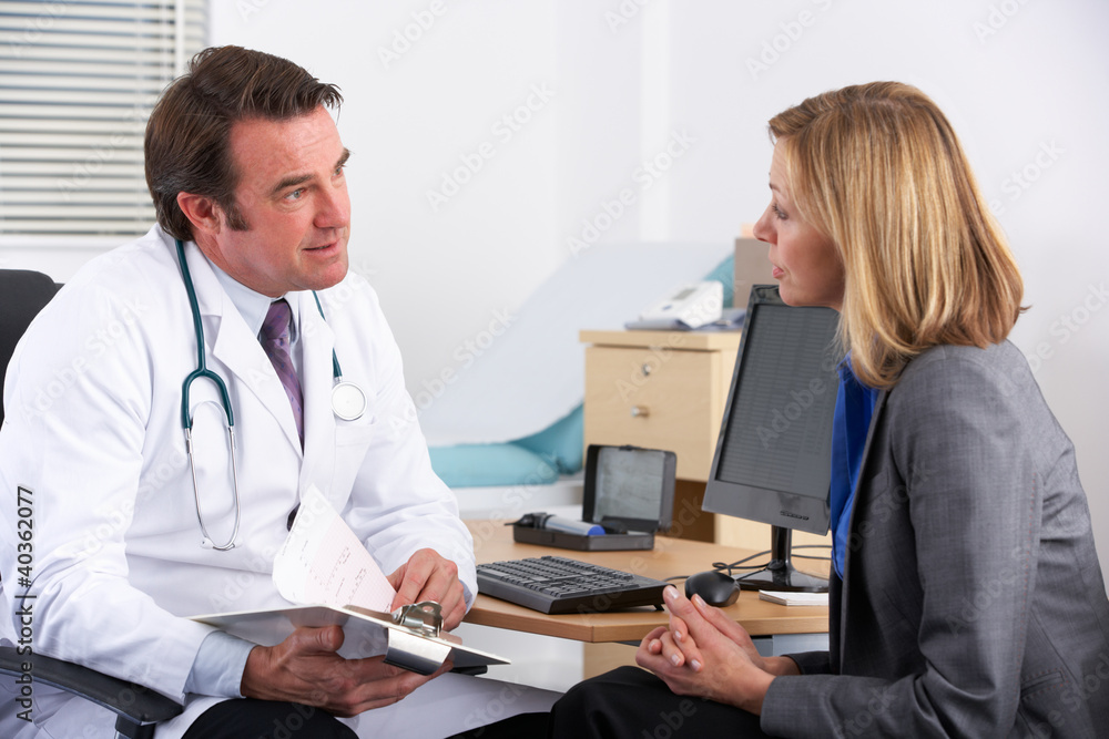 American doctor talking to businesswoman patient American doctor talking to businesswoman patient