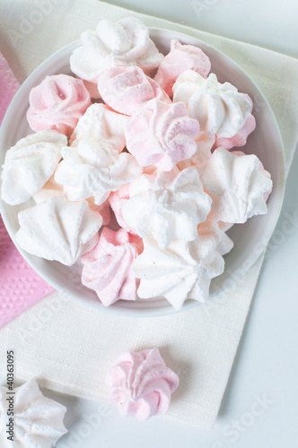 White and pink meringue on a plate