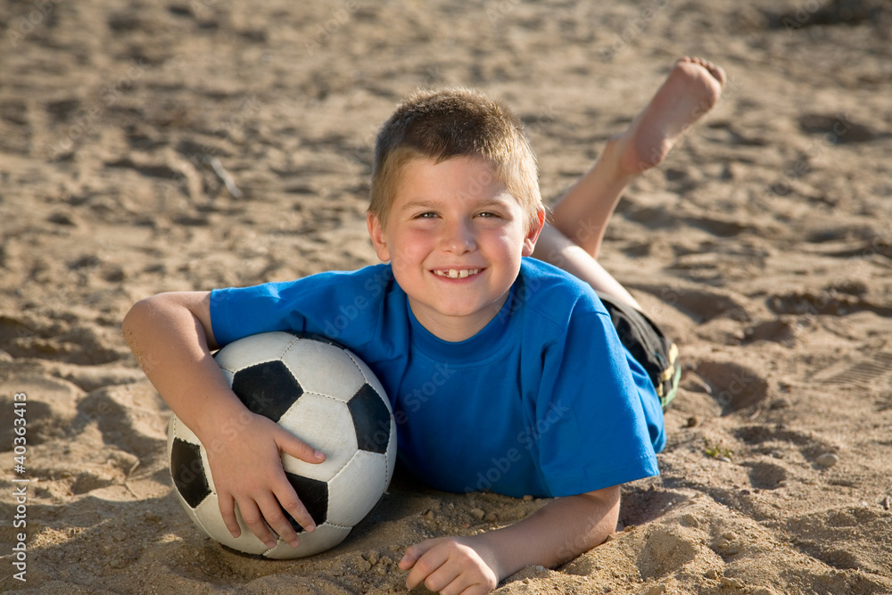 Boy playing  ball on the beach
