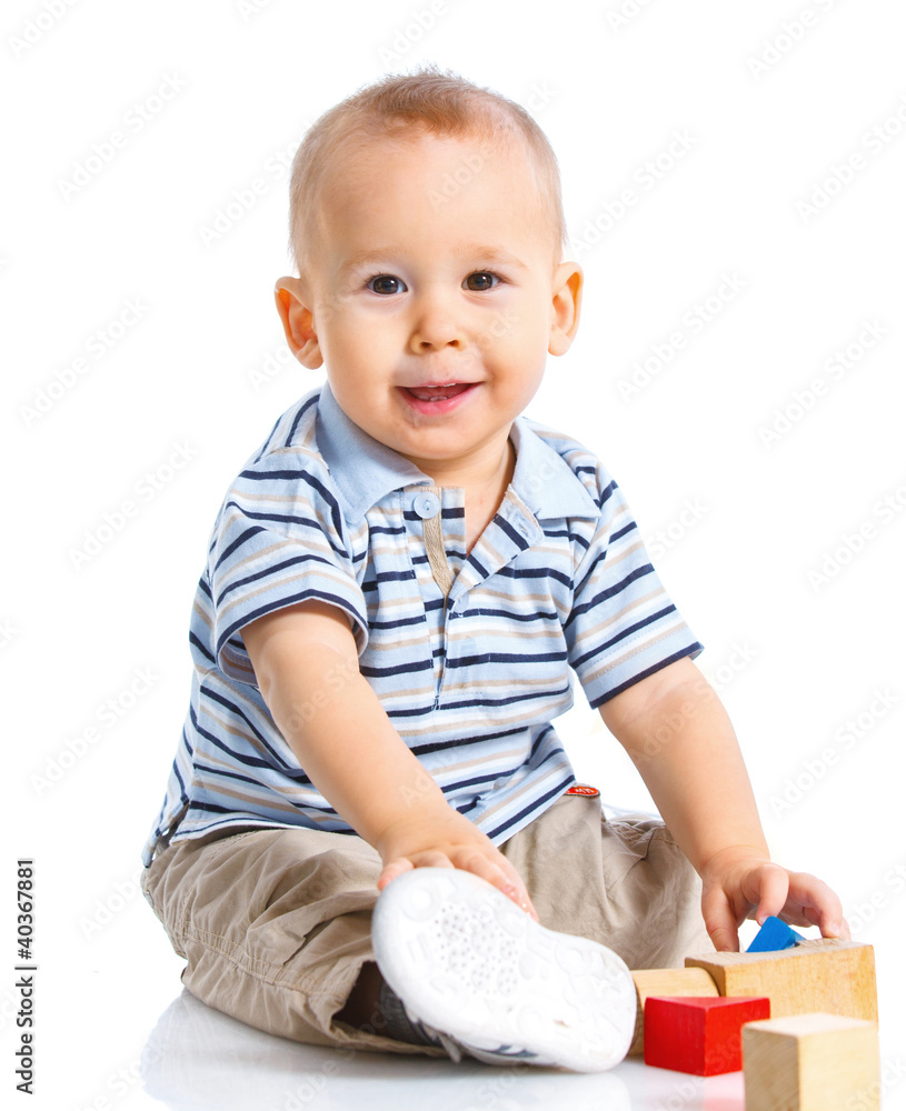 smiling little boy is building