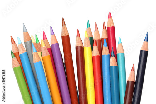 Color pencils over white background