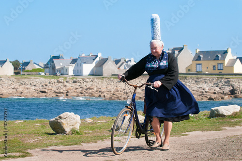 breton women with headdress and bicycle