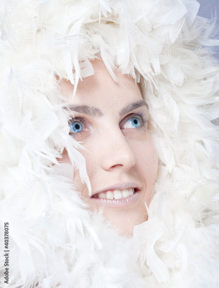 Beautiful woman with white feathers