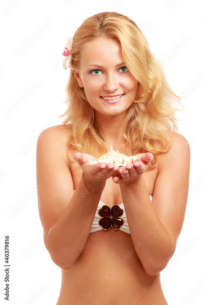 A young woman holding a shell, isolated on white