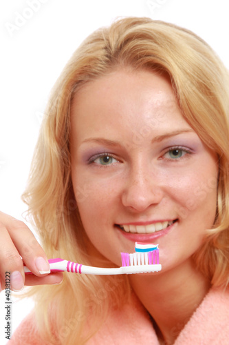 A young woman brushing teeth, closeup, isolated on white