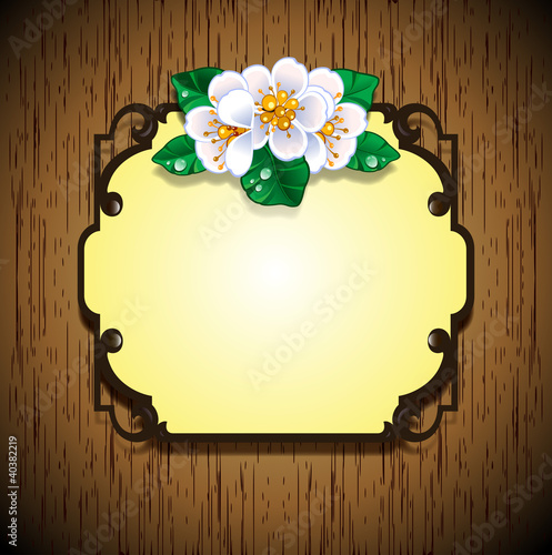 Frame with flowers wooden background