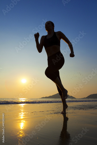 Fototapeta Naklejka Na Ścianę i Meble -  Silhouette woman jogging on the beach