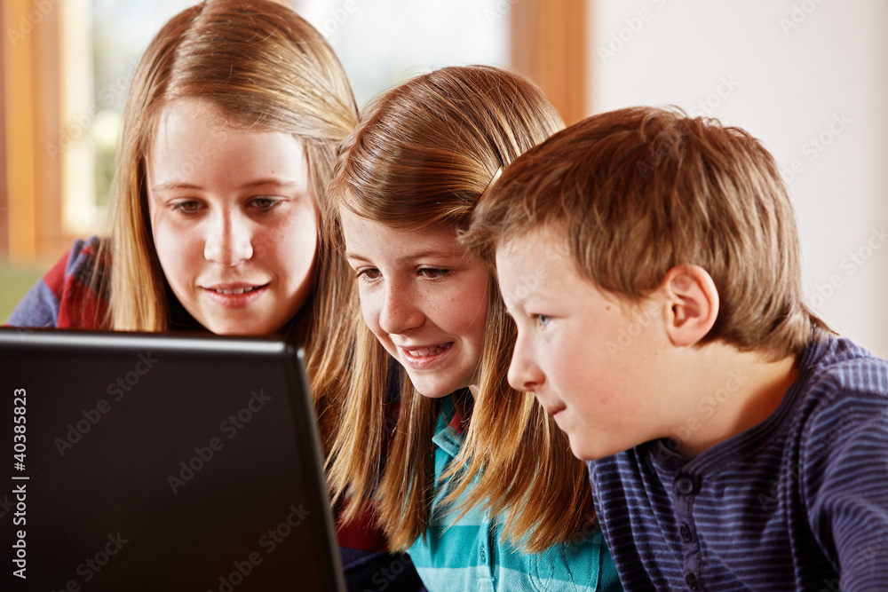 2 girls and a boy at the laptop 2 girls and a boy at the laptop