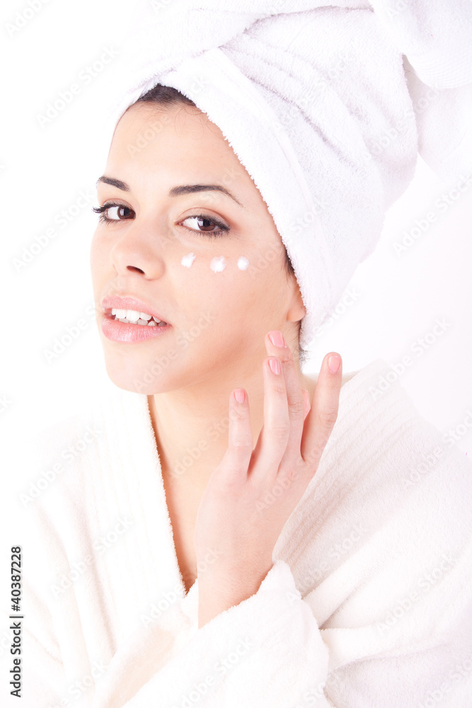 Young beautiful woman applying cream