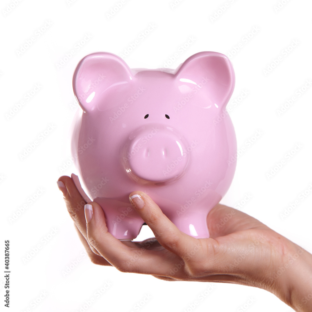 Business woman holding a piggy bank