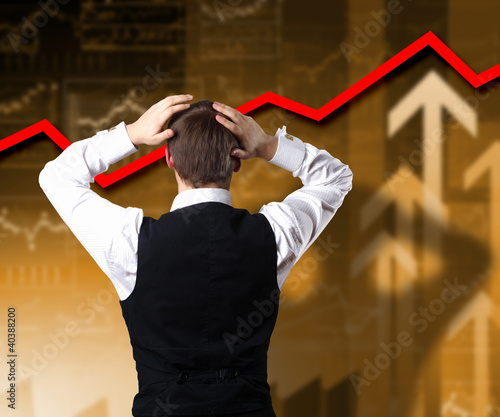 Young businessman against financial graphs photo