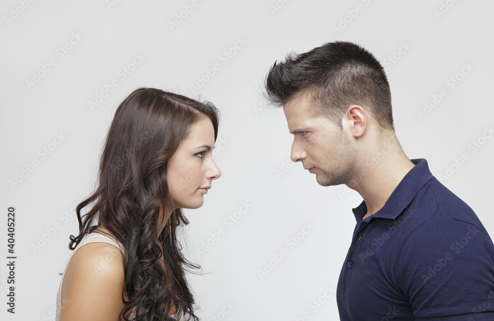 Couple standing against each other Couple standing against each other