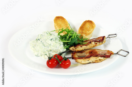 Greek food - tzatziki, chicken souvlaki with bacon and baguette