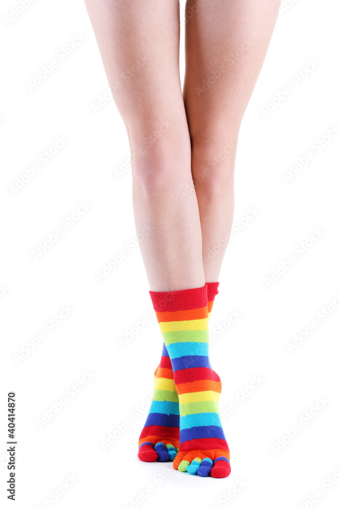 female legs in colorful striped socks isolated on white